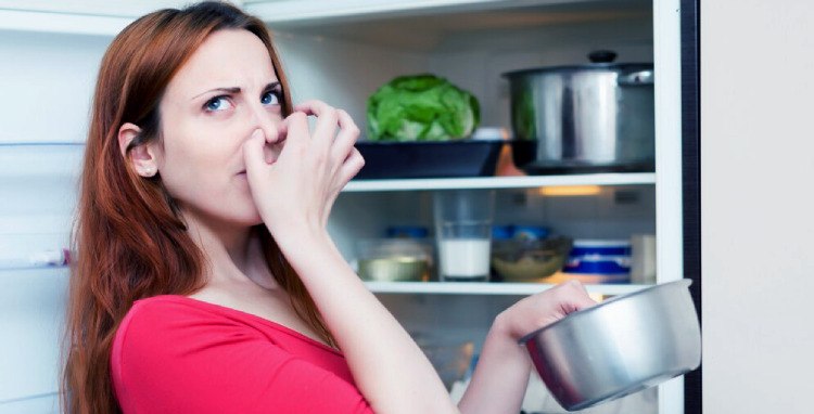 A woman in a red dress covers her nose